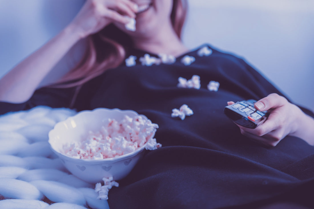 Movie night woman eating popcorn